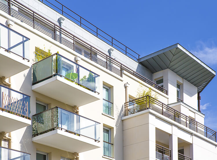 Façade blanche moderne d’un appartement neuf avec balcons